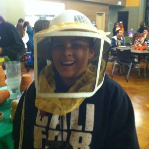 Student in bee keeper mask