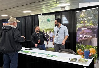 Produce Safety Program staff share food safety educational resources at an information booth at the California Walnut Conference in Turlock.