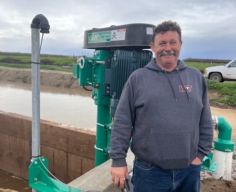 Tiberio Cardoso stands by the new collection pit that agitates and pumps flush water to the separator.